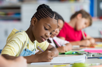 Young children in a classroom studying.