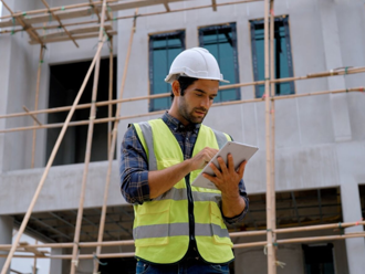 man using a tablet ion a construction site