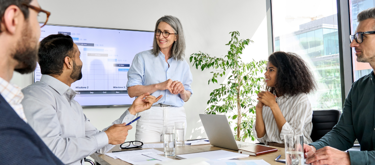 Woman addressing colleagues in meeting