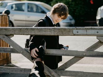 A schoolchild walking home from school.