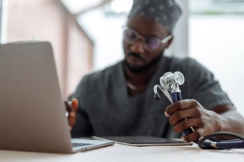 A doctor on a laptop