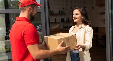 Woman getting a parcel from a delivery driver
