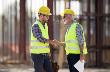two construction managers shaking hands