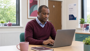 A GP using healthcare software with integrated AI capabilities.