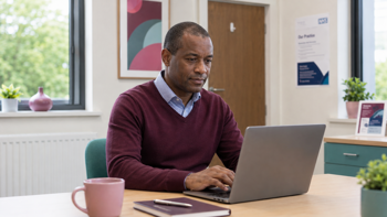 A GP using healthcare software with integrated AI capabilities.