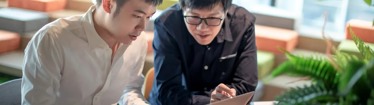 Image of men discussing work