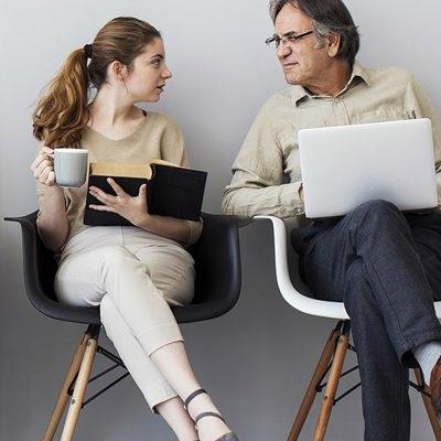 Five people sat on a chair talking to eachother