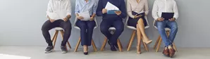 Employees sitting in a row doing a pulse survey
