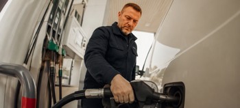 Delivery driver filling his van with diesel