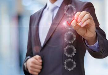 Man ticking a digital checklist. 