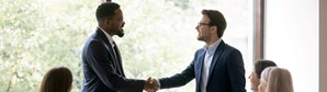 Image of hiring manager shaking hands with potential candidate