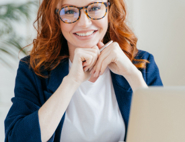 Professional lady with ginger hair and glasses smiling