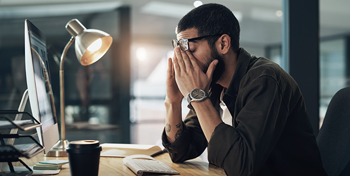 A man stressed at his desk
