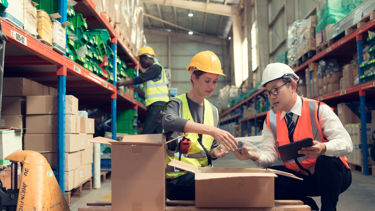 Two men working in the warehouse counting inventory