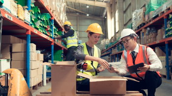 Two men working in the warehouse counting inventory