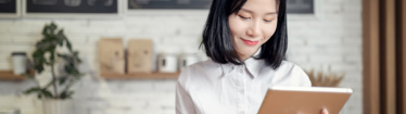 Image of office worker looking at her tablet