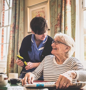A nurse talking to an elderly woman