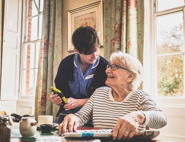 A nurse talking to an elderly woman