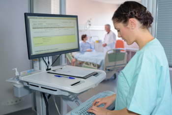 A nurse using healthcare software supported by AI