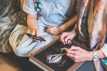 Care planning systems illustrated - Carer and patient looking at a mobile phone