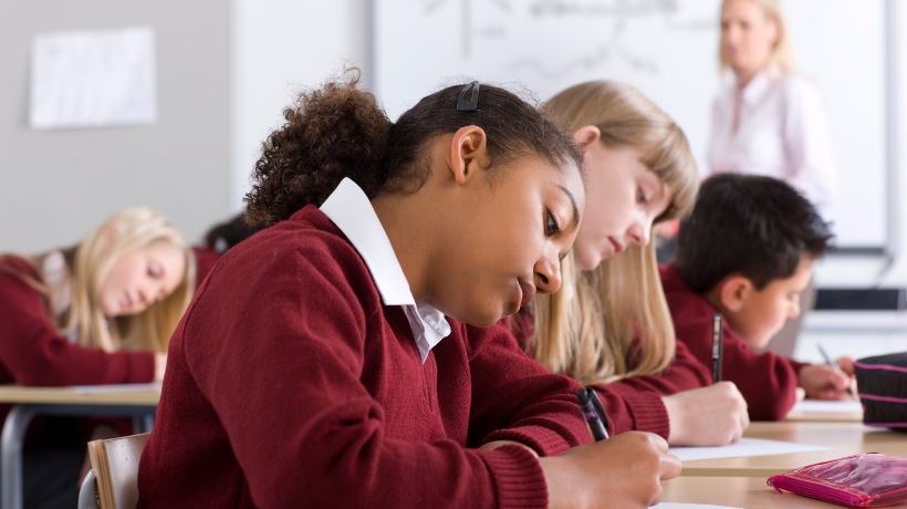 Primary school pupils in class room focusing on work