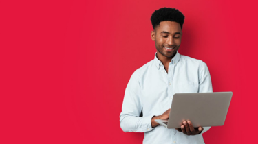 Man on laptop with red background