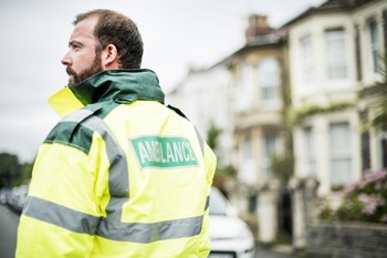 Ambulance staff with his back to the camera