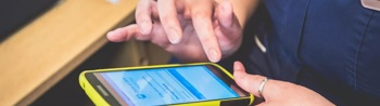 An ICS clinician using a mobile device.