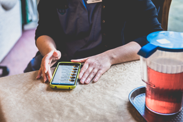 A man with his phone on the table