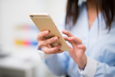 Woman using gold iphone