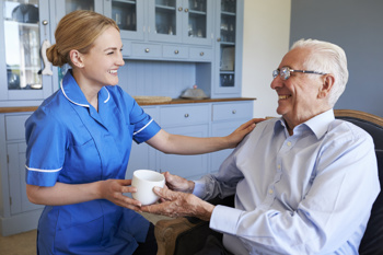 Care worker with elderly person following RQIA regulations