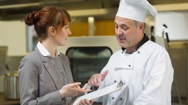 A chef talking to staff