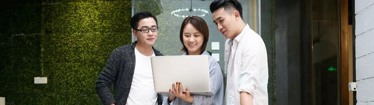 Image of employees engaging with each other while discussing work in the office