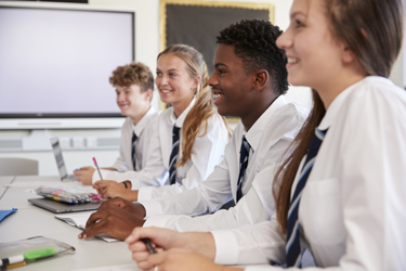 Young teenage students smiling in their uniform 