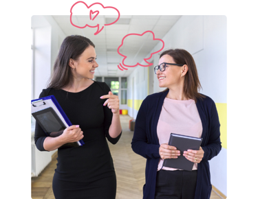 Teachers walking through school corridor talking