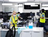 Cleaning staff wearing face masks cleaning an office space