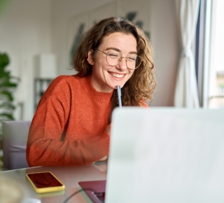 woman smiling at laptop