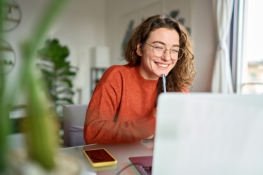 woman smiling at laptop