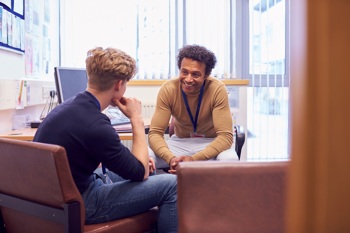 A mental health support worker chatting with a patient.