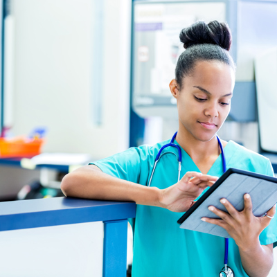 A nurse looking at a tablet 