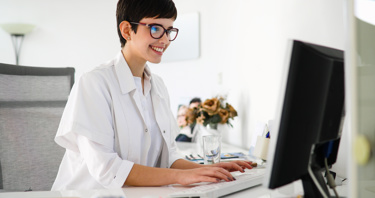 A woman in uniform looking at a computer