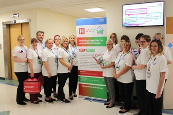 Clinical staff showcasing a new advert for the Red2Green patient flow efficiency process.