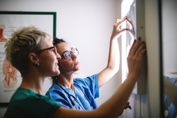Two doctors looking at an X-ray image