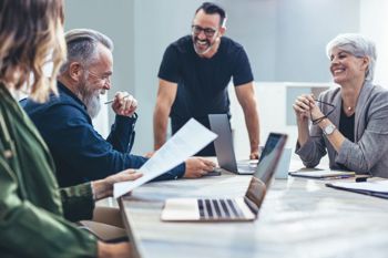 Group of people smiling and learning.