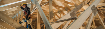 Builder constructing house