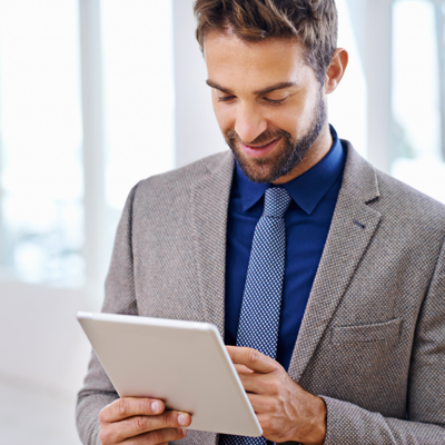 A man in a suit on a tablet