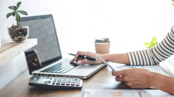 person managing finances a on laptop