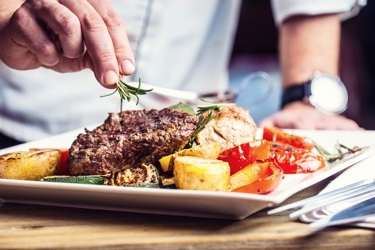 A picture of steak and fries on a plate