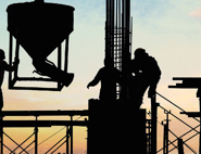 construction workers moving machinery on construction site