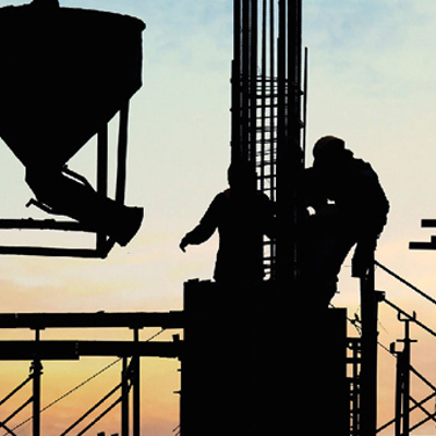 construction workers moving machinery on construction site